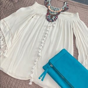 Off the shoulder top with decorative tassels